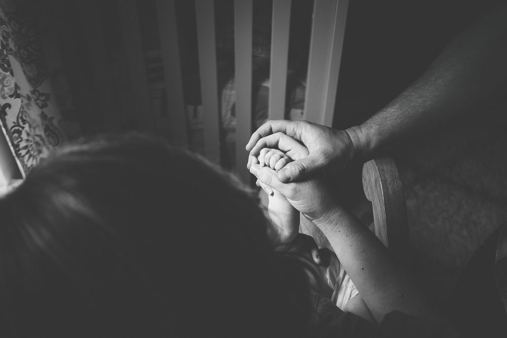 Hands of two generations held together