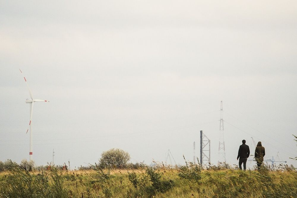Two people walking across an open field